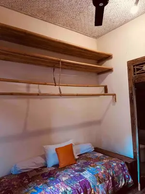 a bedroom with a bed and shelves on the wall at Villa Pisces - 2 Bedrooms Villa with Private Pool at Kerobokan in Denpasar