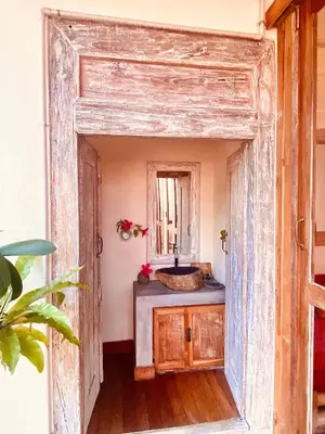 an open door into a bathroom with a sink at Villa Pisces - 2 Bedrooms Villa with Private Pool at Kerobokan in Denpasar