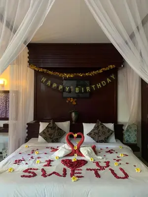 a bed with a heart made out of flowers on it at One Bedroom Private Pool Classic Villa in Kuta
