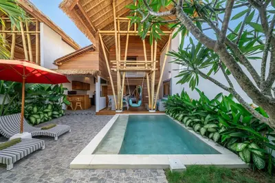 a swimming pool in the courtyard of a villa at The Secret Jungle Villas Seminyak in Seminyak