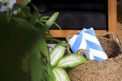 a wicker basket with a blue and white pillow at Villa Nook in Seminyak