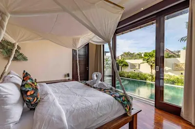 a bedroom with a bed with a view of a pool at 2 Bedroom private Pool Seminyak in Seminyak