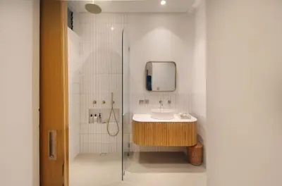 a bathroom with a sink and a mirror and a shower at Jipsi Villas Canggu in Canggu
