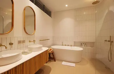 a white bathroom with two sinks and a tub at Jipsi Villas Canggu in Canggu