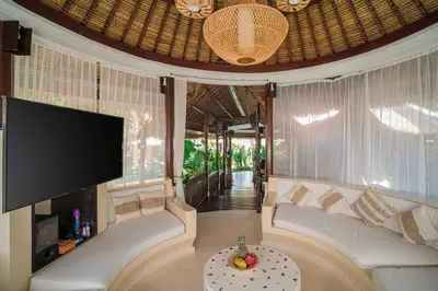 a living room with a couch and a flat screen tv at Villa Coconut Heaven by Bali Villa Solutions in Seminyak
