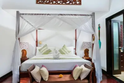 a bedroom with a white bed with a canopy at Chandani 3 BR Private Pool Villa in Ujung