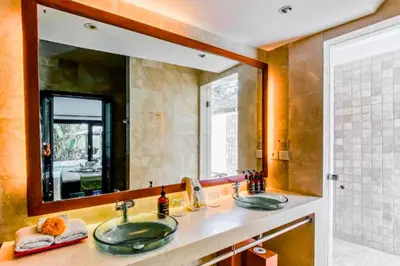 a bathroom with two sinks and a large mirror at Chandani 3 BR Private Pool Villa in Ujung