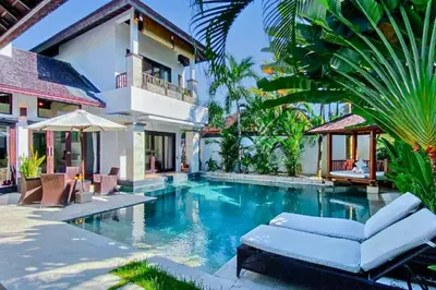 a swimming pool in front of a villa at Chandani 3 BR Private Pool Villa in Ujung