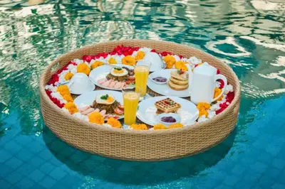 a tray of food in a swimming pool at Charvi 1 BR Private Pool Villa in Ujung