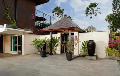 a building with potted plants in front of it at Shanti Estate Seminyak by Nakula in Seminyak