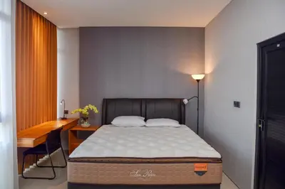 a bed in a room with a desk and a bed sidx sidx sidx at MINI Coliving Apartment in Seminyak