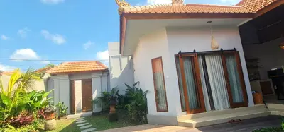 a small white house with a red roof at Sarayu Villa 2 - Serene and peaceful 2BR private Villa in Seminyak