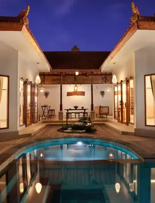 a villa with a swimming pool at night at Sarayu Villa 2 - Serene and peaceful 2BR private Villa in Seminyak