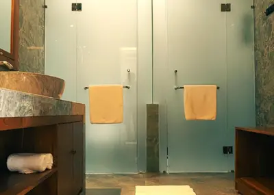 a bathroom with green walls and orange towels at Sarayu Villa 2 - Serene and peaceful 2BR private Villa in Seminyak