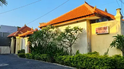 a yellow house with an orange roof on a street at Sarayu Villa 2 - Serene and peaceful 2BR private Villa in Seminyak
