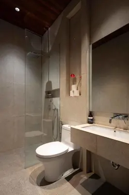 a bathroom with a toilet and a shower and a sink at ALENY Vila by VoLa in Seminyak