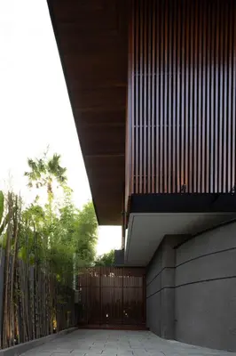 a building with a wooden fence and a gate at ALENY Vila by VoLa in Seminyak