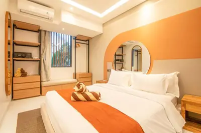 a bedroom with a bed with a dog sitting on it at Marvelous 6BR 2 mins to Beach in Canggu