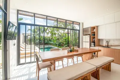 a kitchen and dining room with a table and chairs at Marvelous 6BR 2 mins to Beach in Canggu