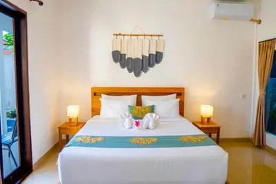 a bedroom with a bed with two stuffed animals on it at Villa Majegau 4 Seminyak in Seminyak