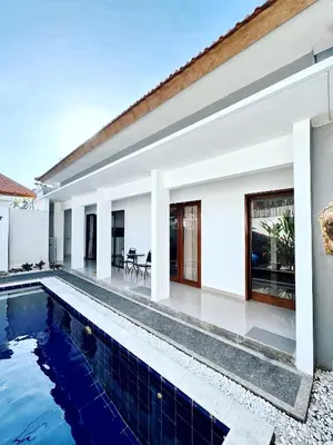 a villa with a swimming pool and a house at Villa Majegau 4 Seminyak in Seminyak