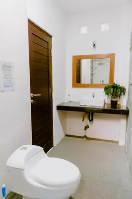 a bathroom with a white toilet and a sink at Villa Majegau 4 Seminyak in Seminyak