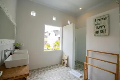 a bathroom with a sink and a window at Deja Blu Villa in Seminyak