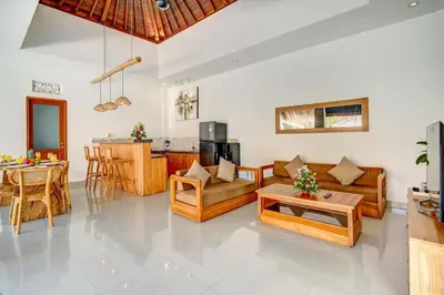 a living room with a couch and a table at Villa Esha II in Seminyak