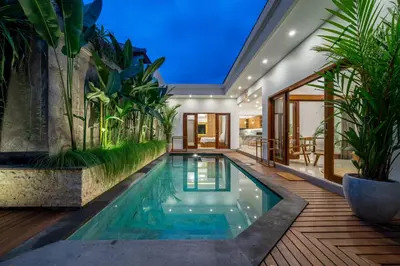 an indoor pool in a house with plants at Sundaze 3 - Villa with Huge Pool and Kitchen in Canggu