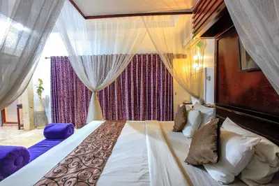 a bedroom with a large bed and a window at Privat Pool villa at kuta in Kuta