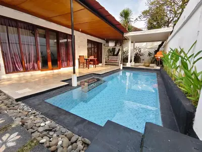 a swimming pool in the backyard of a house at Privat Pool villa at kuta in Kuta