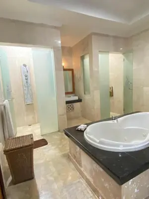 a large bathroom with a tub and a shower at Privat Pool villa at kuta in Kuta