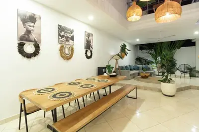 a living room with a table and a couch at Boho-chic Canggu Villa near Cafè Del Mar, 5-minute walk to beach in Canggu