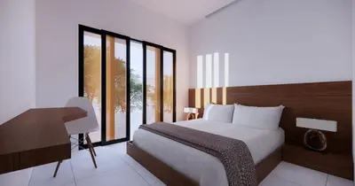 a bedroom with a bed and a desk and windows at Uger House Seminyak in Seminyak
