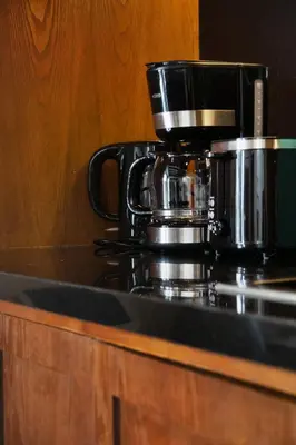 a coffee pot sitting on top of a stove at The Urban Retreat Seminyak Private Pool Villas with Butler for Families & Groups in Seminyak