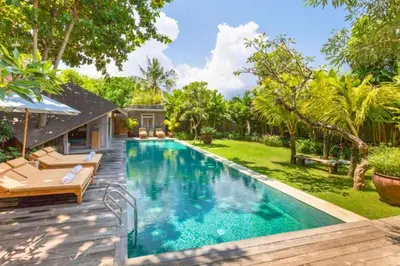 a swimming pool in the backyard of a house at Janardana 4 BR Private Pool Villa ZN157 in Canggu