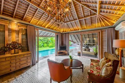 a living room with a wooden ceiling and a table at Janardana 4 BR Private Pool Villa ZN157 in Canggu