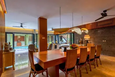 a dining room with a wooden table and chairs at Janardana 4 BR Private Pool Villa ZN157 in Canggu