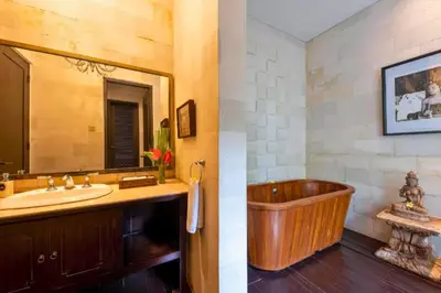a bathroom with a wooden tub and a sink at Janardana 4 BR Private Pool Villa ZN157 in Canggu