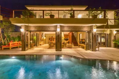 a house with a swimming pool in front of a house at Janardana 4 BR Private Pool Villa ZN157 in Canggu