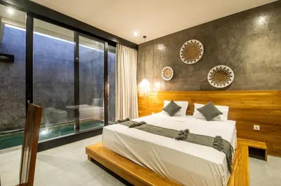 a bedroom with a bed and a large window at Minimalist Villa with Pool #Nico1 in Canggu