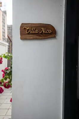 a sign on the side of a wall at Minimalist Villa with Pool #Nico1 in Canggu