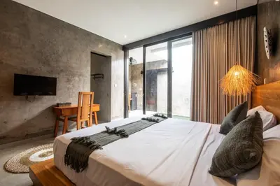 a bedroom with a large bed and a large window at Minimalist Villa with Pool #Nico1 in Canggu