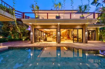 a large house with a swimming pool in front of it at Janya 3 BR Private Pool Villa ZN158 in Canggu