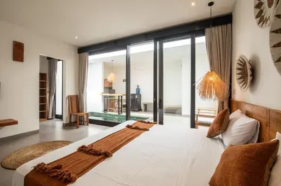 a bedroom with a large white bed in a room at Minimalist Villa with Pool #Lina2 in Canggu