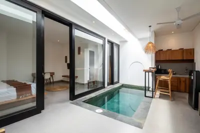 a room with a swimming pool in the middle of a house at Minimalist Villa with Pool #Lina2 in Canggu