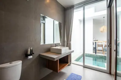 a bathroom with a sink and a mirror at Minimalist Villa with Pool #Jade3 in Canggu