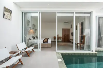 a living room with a pool and a bedroom at Minimalist Villa with Pool #Jade3 in Canggu