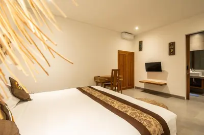 a bedroom with a bed and a desk and a sink at Minimalist Villa with Pool #Jade3 in Canggu