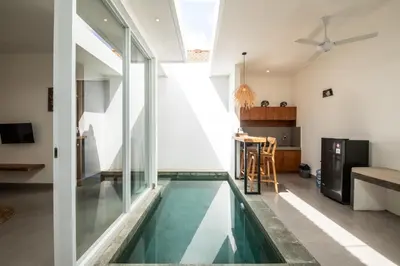 a house with a swimming pool in the middle of a room at Minimalist Villa with Pool #Jade3 in Canggu